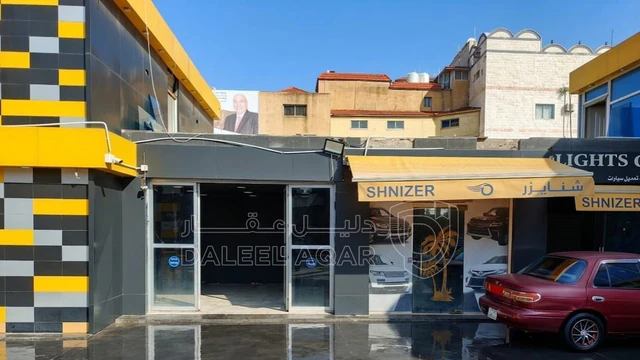 أرض في ارض تجارية للبيع مع محطة غسيل ومحلات للبيع  - 750,000 دأ - صورة NaN
